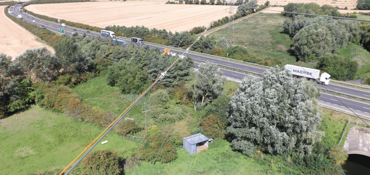 Overhead tower lines crossing road, costain