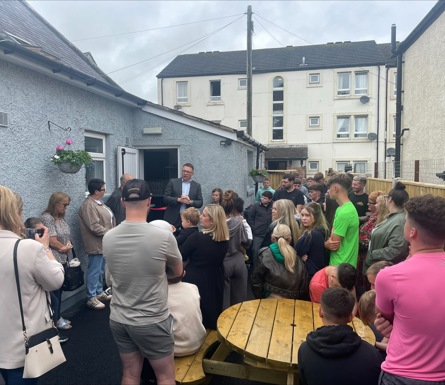 A crowd of people standing outside a building