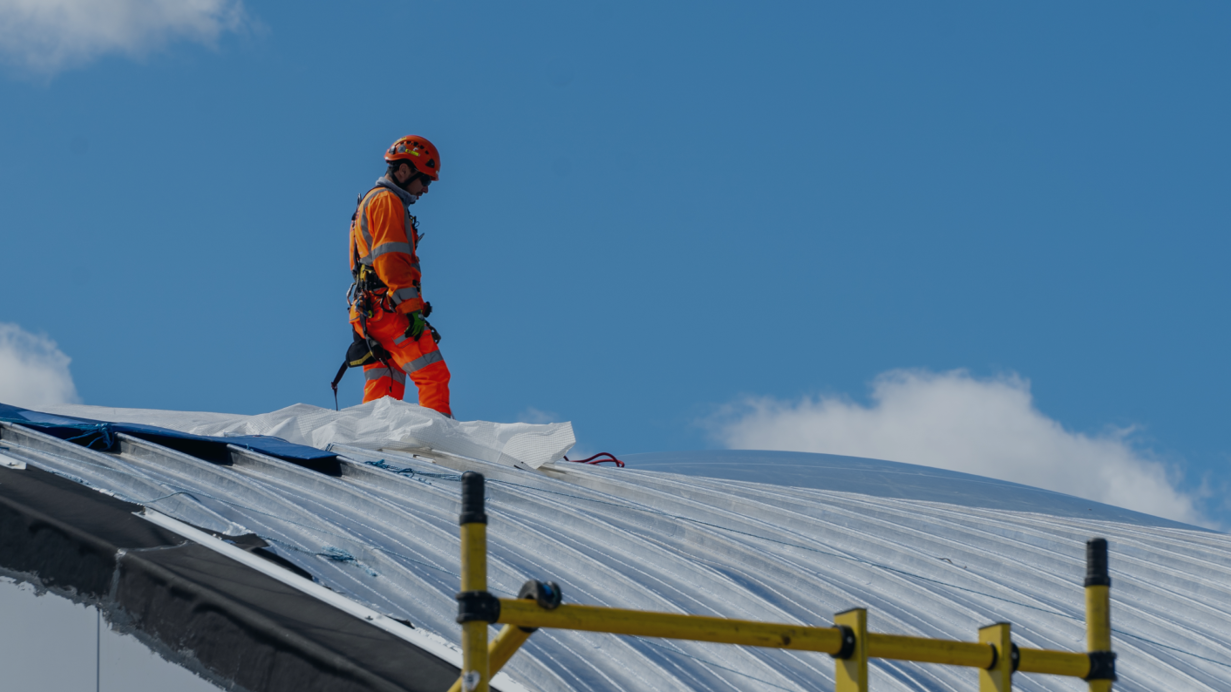Image 1 - Man on roof