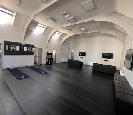 The interior of a building including televisions and entertainment